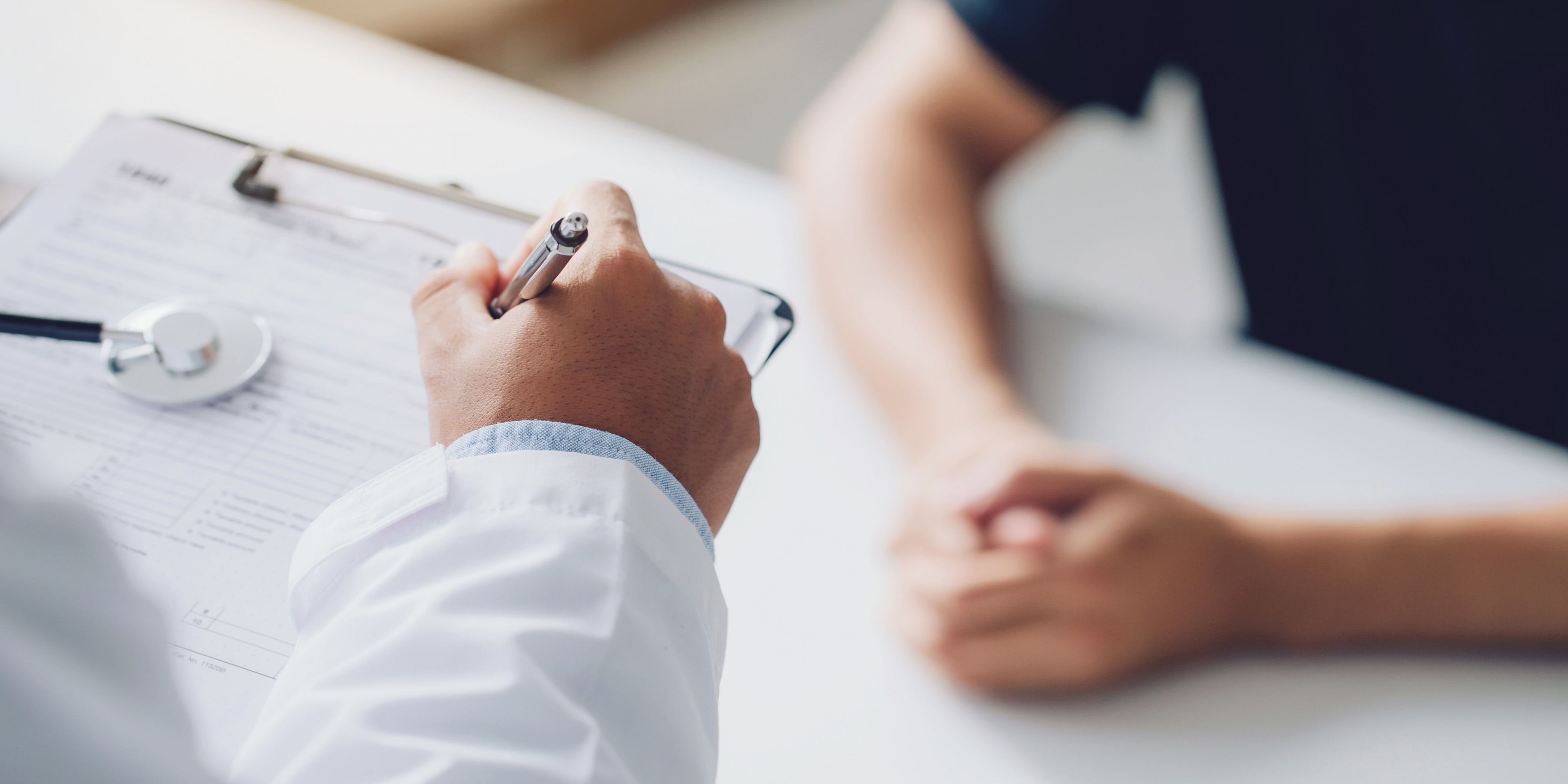 Image of a doctor taking notes