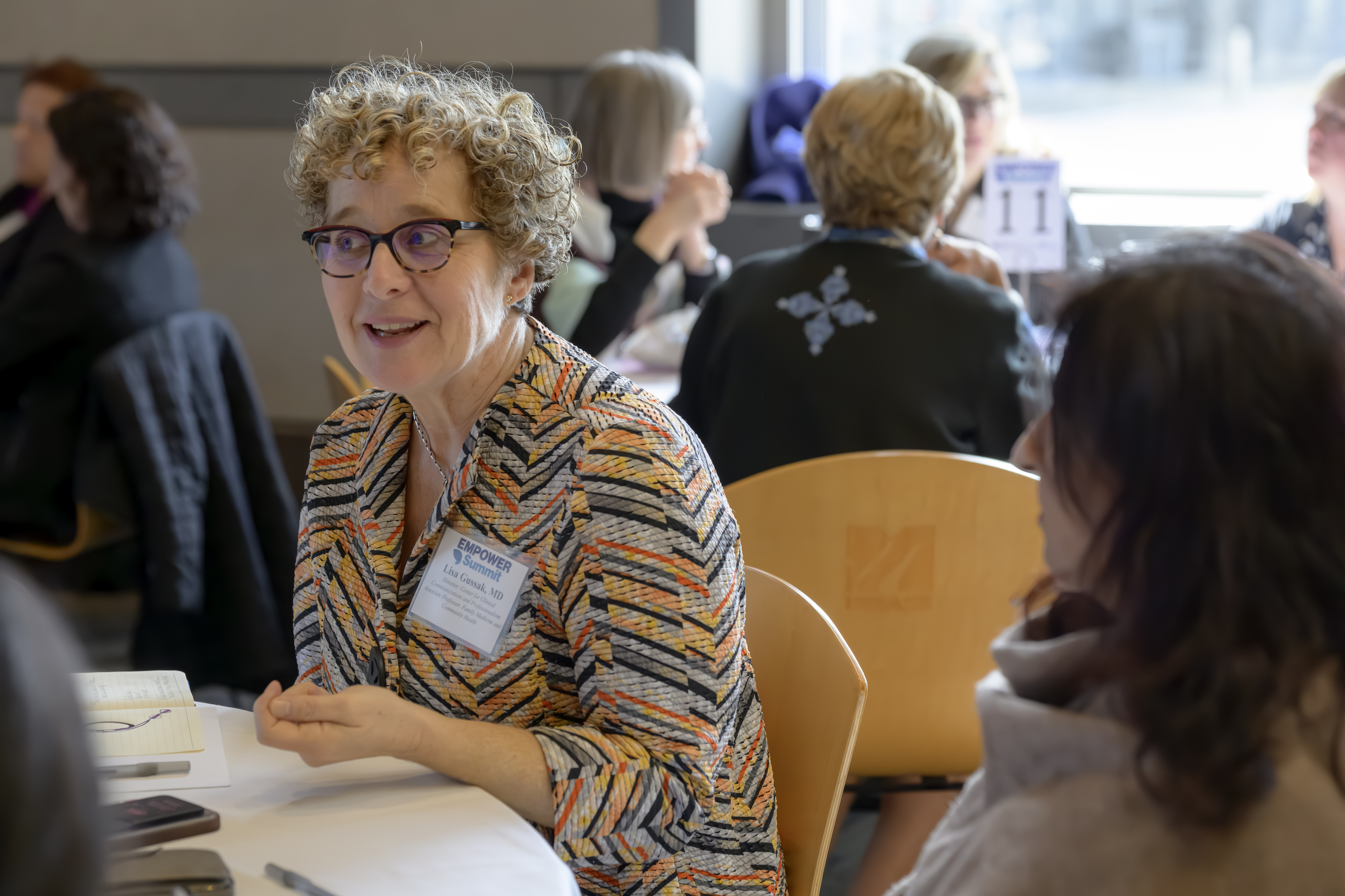 woman sitting at table smiling