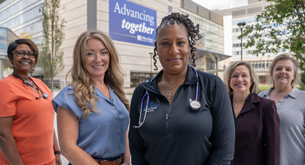 Students in the MS - Nursing and Interprofessional Leadership program standing in front of the Advancing together sign