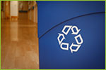 Image shows a close up of a blue recycling bin  
