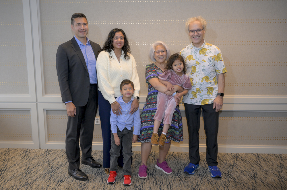 Ambros and Lee stand with their son, daughter-in-law and grandchildren at the UMass Club in Boston on the day of the Nobel announcement.&nbsp;