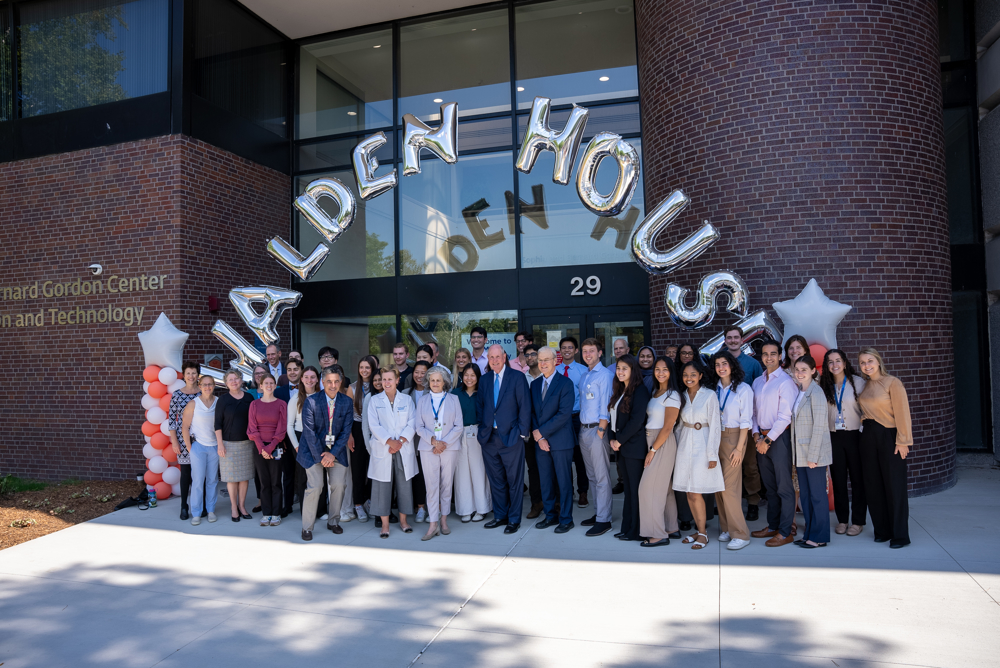 The inaugural cohort of LEAD@Lahey medical students&mdash;32 strong&mdash;gather on the UMass Chan-Lahey regional campus in Burlington. They are gathered in front of a building below a balloon arch thats spells out Walden House. 