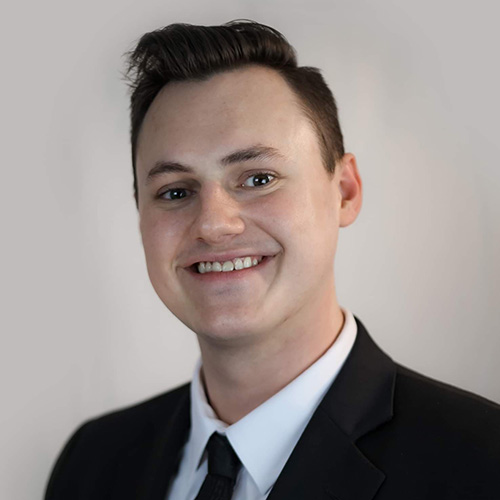 white man in a suit with short dark hair