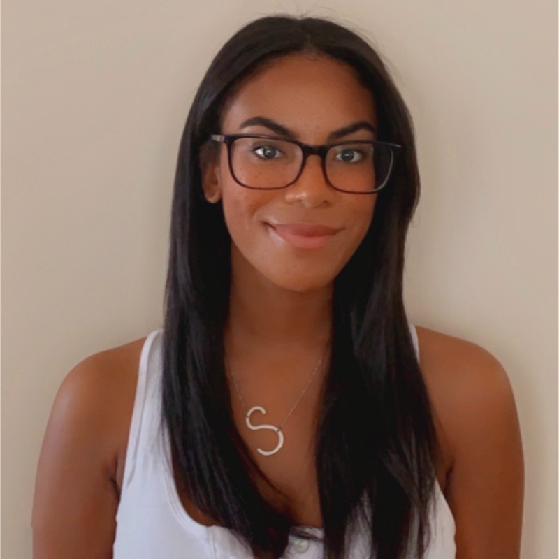 brown woman with long dark hair and glasses