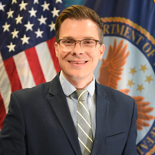white man in a suit with glasses