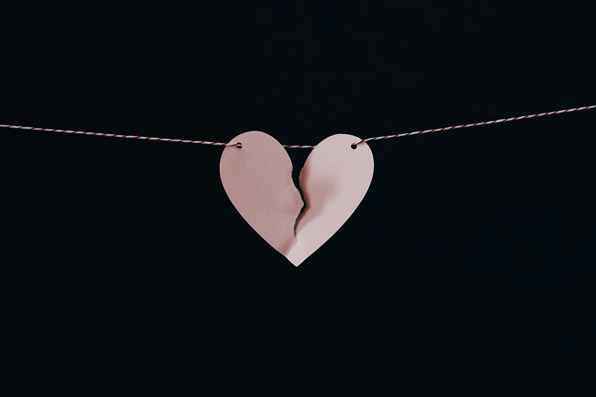 broken paper heart hanging on a string