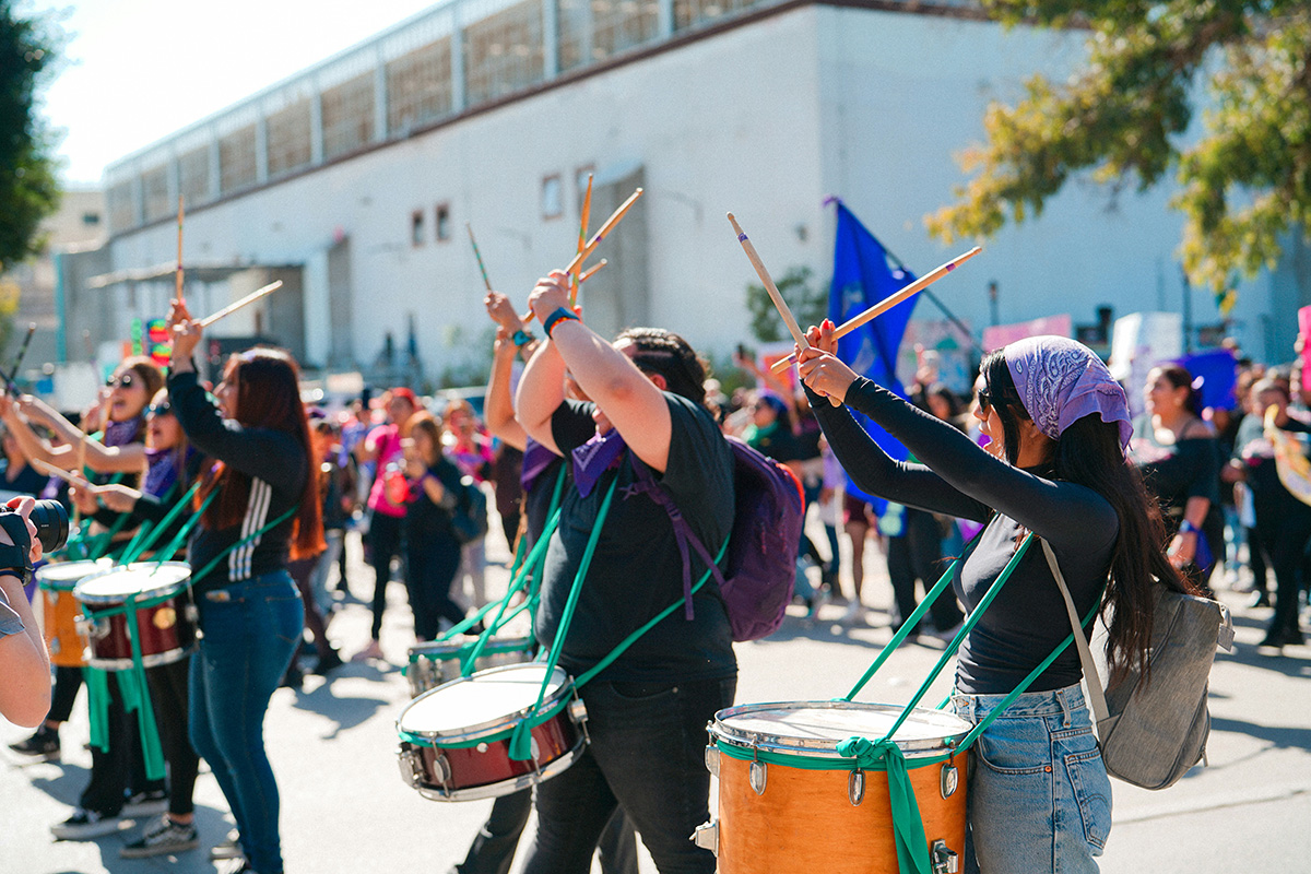 woman playing drums in the street