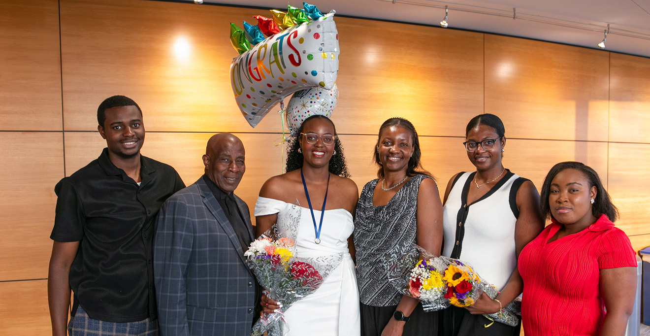 Kay-Ann Davis, the Student Daisy Award recipient, smiling with family members. 