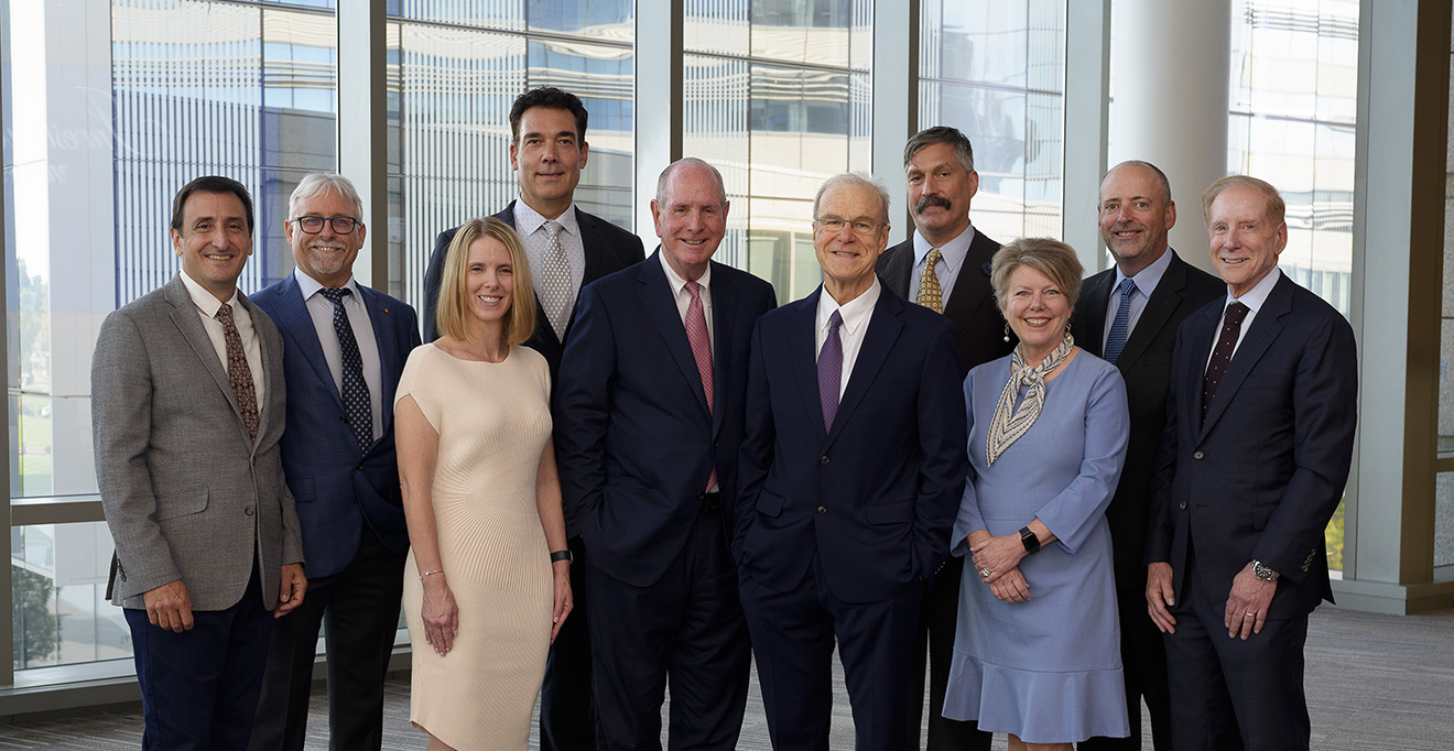 The nine faculty members honored and invested as endowed professors stand with Chancellor Michael F. Collins (center). From left to right: Christopher M. Sassetti, PhD; Craig L. Peterson, PhD; Stephenie C. Lemon, PhD; Richard I. Gregory, PhD; Terence R. Flotte, MD; Oliver Rando, MD, PhD; Anne C. Larkin, MD; Paul Thompson, PhD; and Kenneth L. Rock, MD