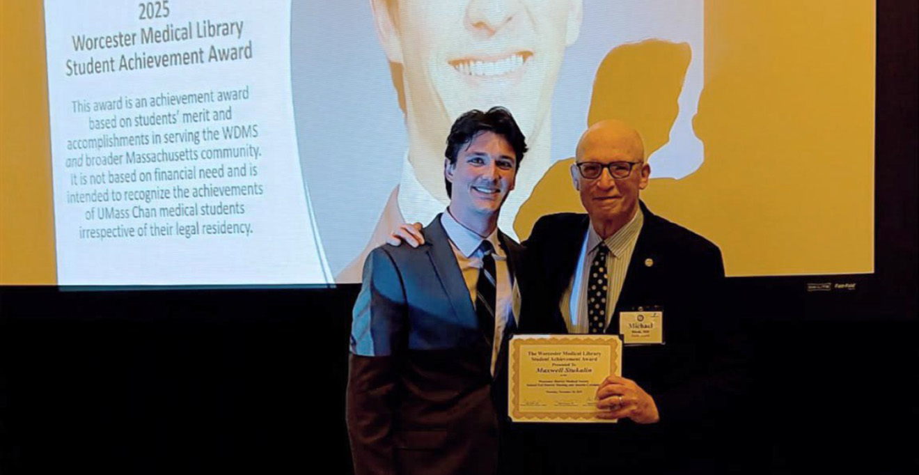 Maxwell Stukalin accepts the Worcester Medical Library Medical Student Achievement Award from Michael P. Hirsh, MD, professor of surgery