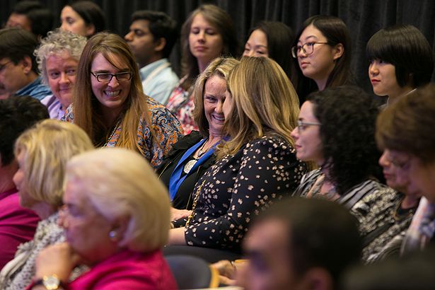 Anne Gilroy is congratulated by colleagues.